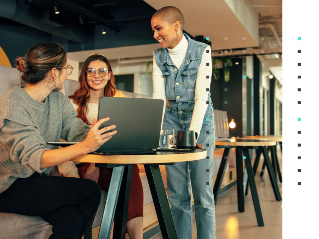 three coworkers meeting around a laptop